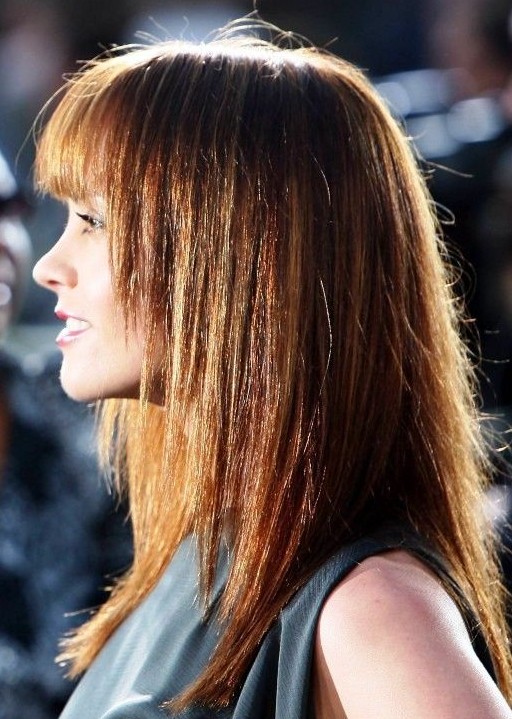 Side View of Long Brunette Hairstyle with Blunt Bangs