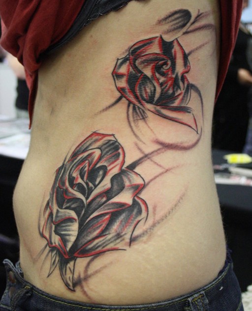 Rose tattoo on side of body