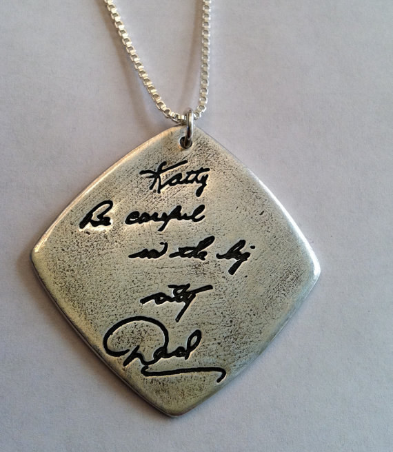 A pendant with an engraved message in Your Handwriting