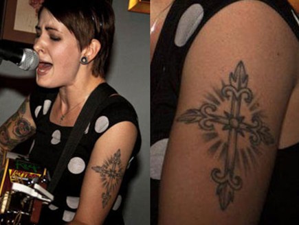 Beth Lucas tattoos – gleaming Christian cross on left arm