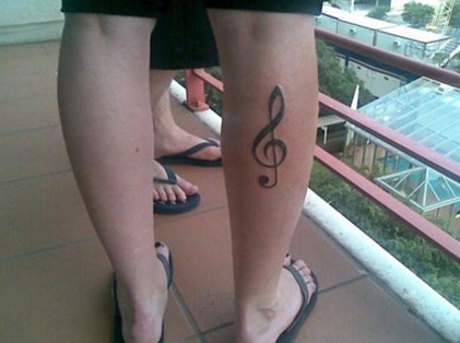 Beth Lucas tattoos – treble clef music symbol right leg