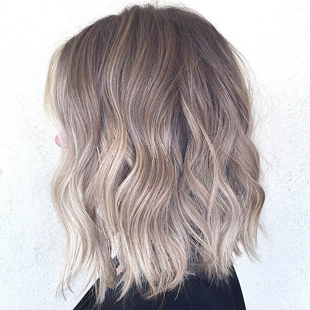 layered brownish blonde lob hairstyle for thick hair