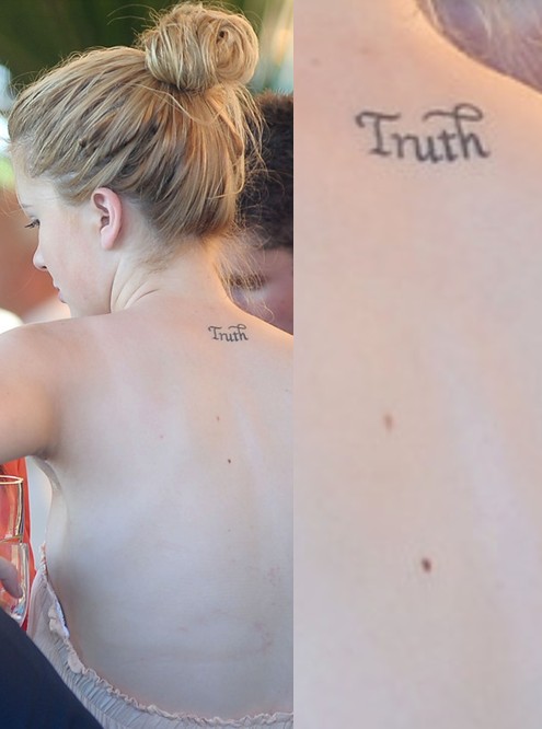 Ireland Baldwin's Tattoos - Lettering Tattoo on Upper Back