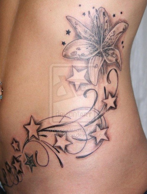 Flower star tattoos on side of body