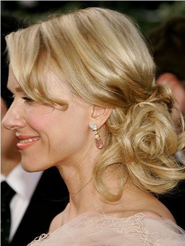 The Low Messy Side Bun Hairstyle for Long Wavy Blond Hair