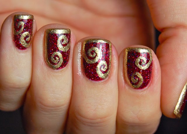 Burgundy Nail Design With Gold Swirl