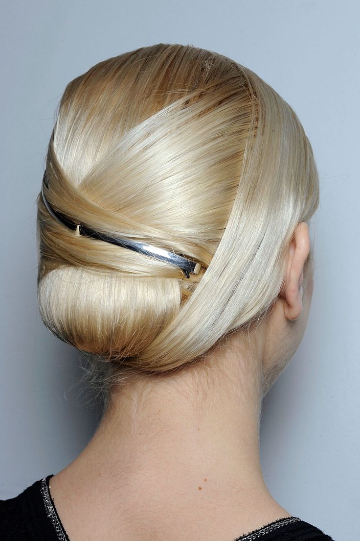 Sleek Updo Hairstyle with Metallic Accessory