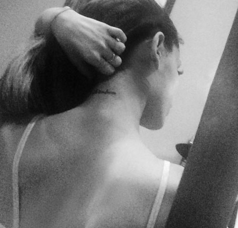 Ariana Grande tattoos – nape of neck script tattoo