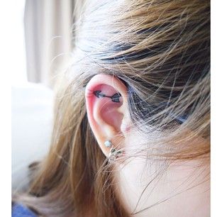 Arrow Inner Ear Tattoo