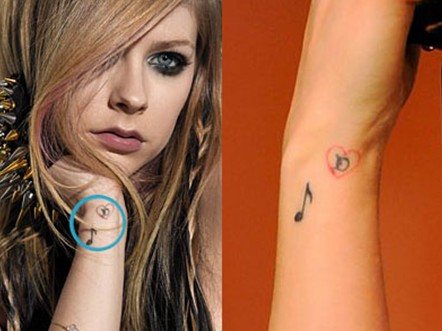 Avril Lavigne tattoos – ‘D’ enclosed in red heart with Deryck Whibley, plus musical note