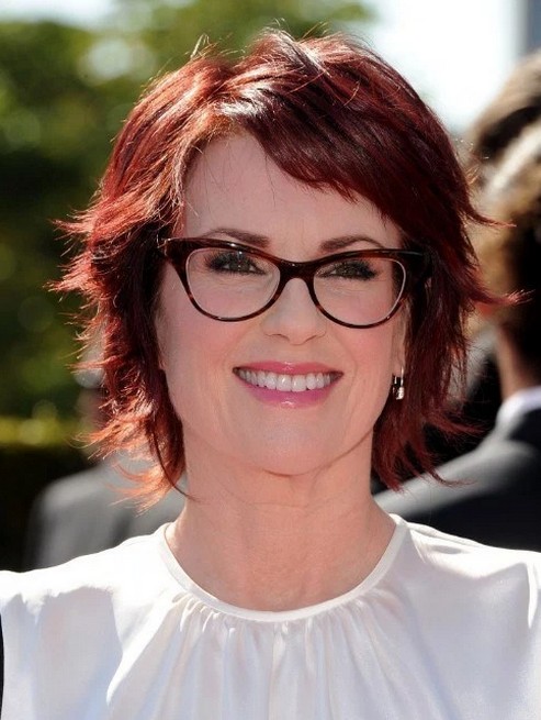 Layered short red hairstyle with glasses for women over 50