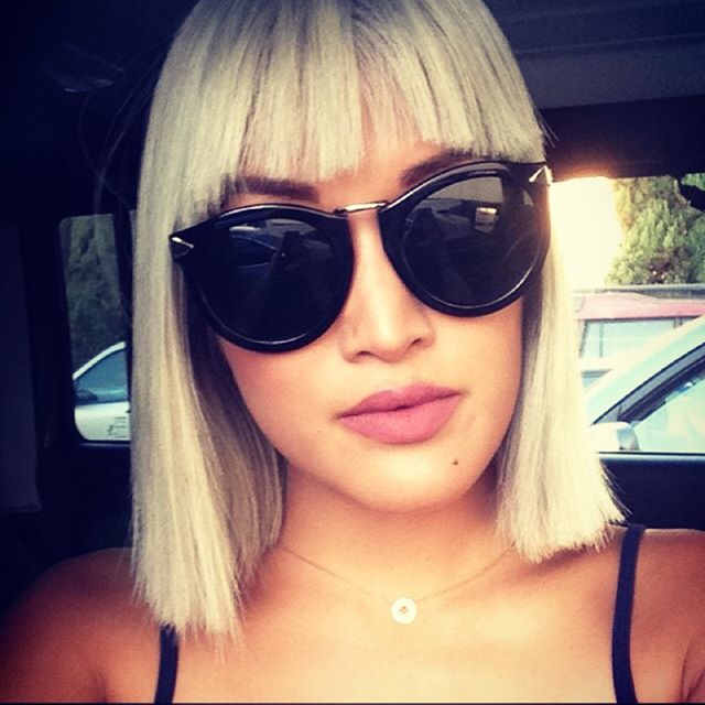 trendy blonde blunt bob cut with sun glasses